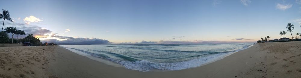Panoramic view of beach against sky during sunset