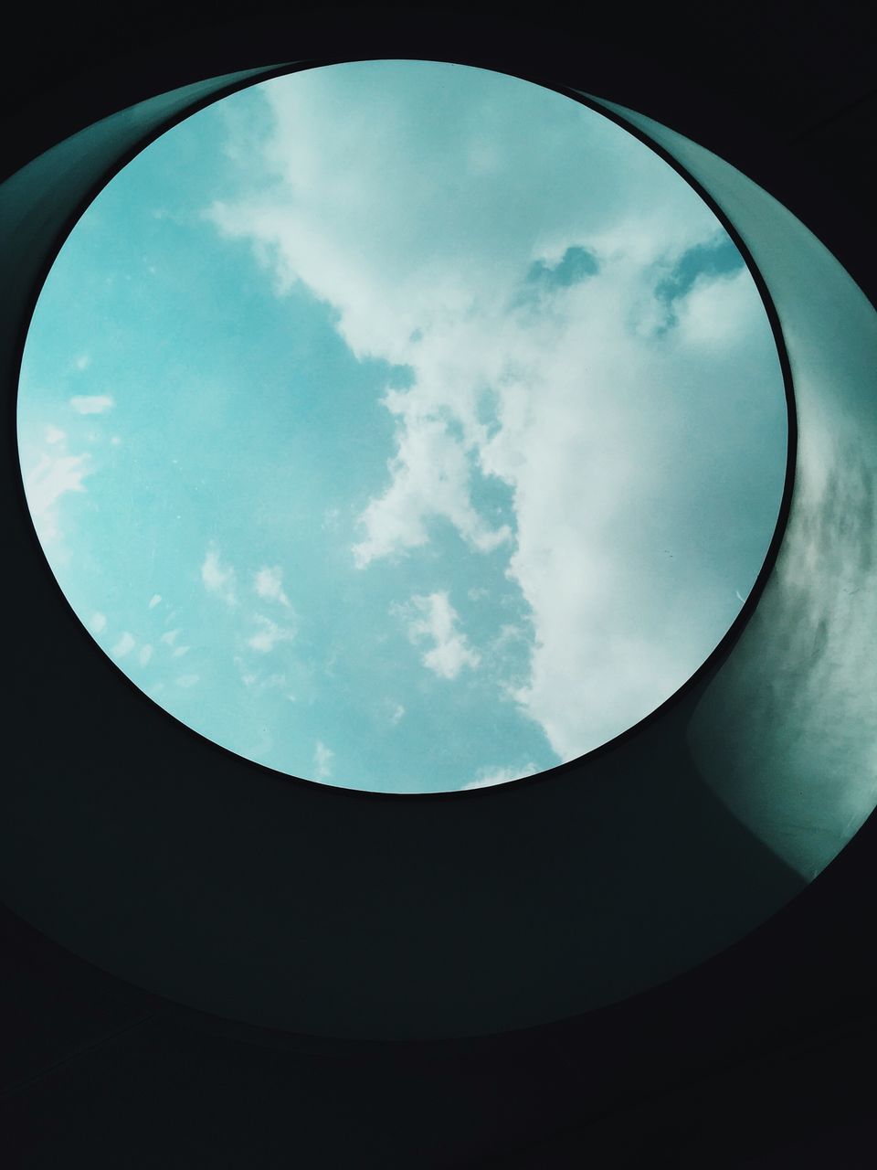 circle, sky, low angle view, geometric shape, cloud - sky, indoors, built structure, architecture, directly below, arch, fish-eye lens, cloud, shape, cloudy, no people, day, silhouette, window, round, nature