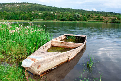 Sunken wooden fisherman boat . old wooden barque . picturesque river nature