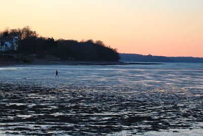 Scenic view of sea against clear sky during sunset