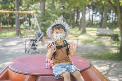 Portrait of cute girl sitting on swing