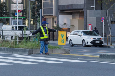 Full length of man cycling on road
