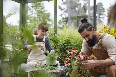 Smiling couple in greenhouse