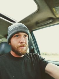 Portrait of young man in car