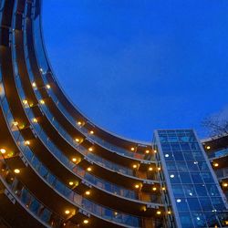 Low angle view of illuminated building against blue sky