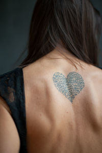 Rear view of woman with tattoo