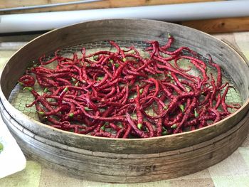 High angle view of red chili peppers in bowl on table