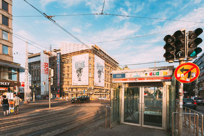 View of city street and buildings against sky