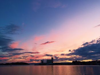 Scenic view of sea against dramatic sky during sunset