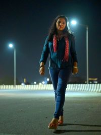 Portrait of young woman looking away at night