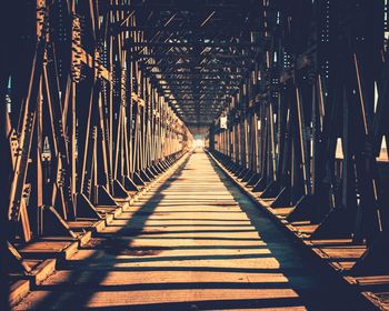 Empty footbridge during sunny day