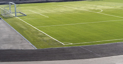 Soccer goal, football gate. green synthetic grass sport field with white line. sports background.