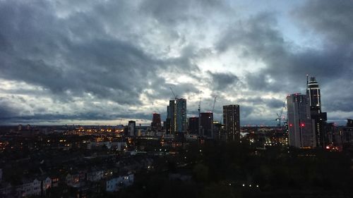 Panoramic view of illuminated buildings in city against sky
