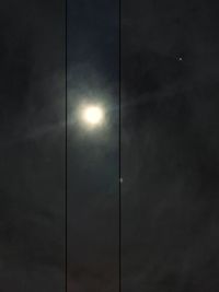 Low angle view of illuminated street light against sky