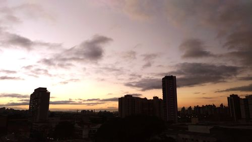 Silhouette buildings against sky during sunset