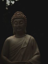 Close-up of statue against black background