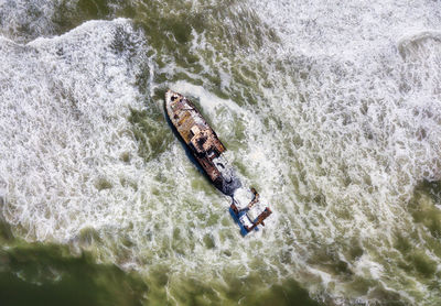 Aerial view of abandoned ship in sea against sky