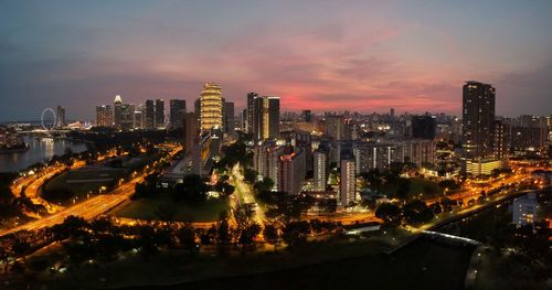 Aerial view of illuminated buildings in city against sky