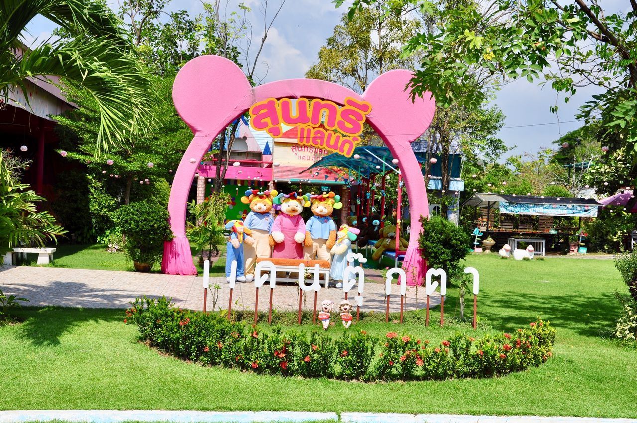 GROUP OF PEOPLE IN PARK BY TREES