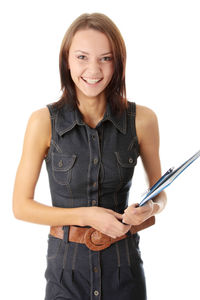 Portrait of smiling young woman standing against white background