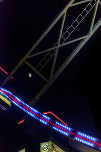 Low angle view of illuminated building against sky at night