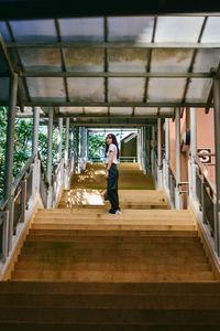 Side view of woman walking on staircase