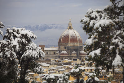 Florence cathedral in city against sky during winter