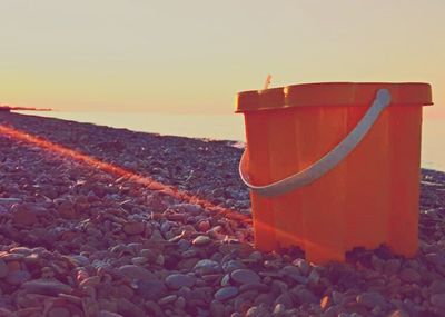 Red umbrella on beach during sunset