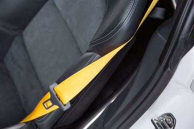 Close-up of yellow seat belt in car