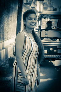 Portrait of smiling young woman standing outdoors