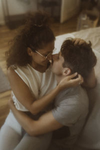 Romantic couple spending leisure time while rubbing noses at home