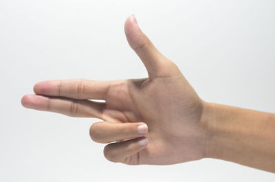 Close-up of human hand against white background