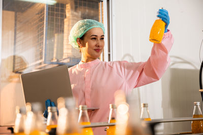 Young woman drinking in laboratory