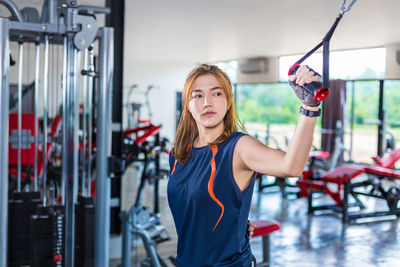 Young woman exercising in gym