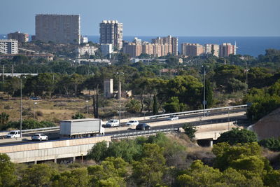 High angle view of buildings and trees against sky