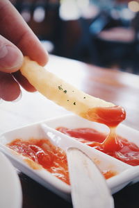 Close-up of hand holding fried potato