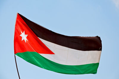 Low angle view of flag against clear sky