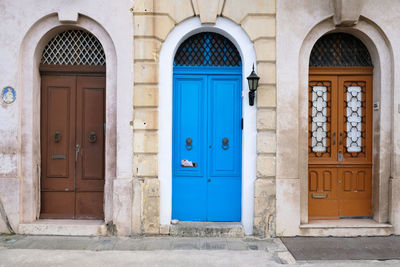 Traditional vintage painted wooden door and exterior in malta. entrance to typical maltese houses.