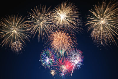 Low angle view of firework display at night