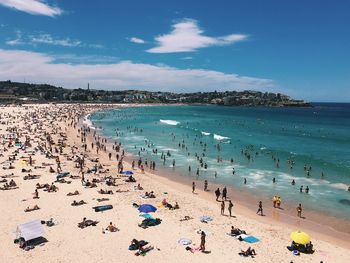 People on beach against sky