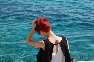 Rear view of woman standing in sea