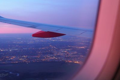 Aerial view of cityscape against sky seen through airplane window