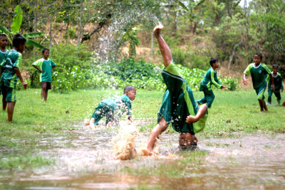 Group of people running on water