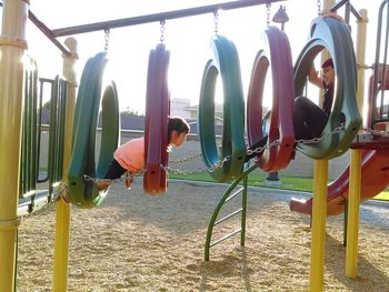 Panoramic shot of men hanging against sky