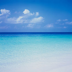 Scenic view of sea against cloudy sky