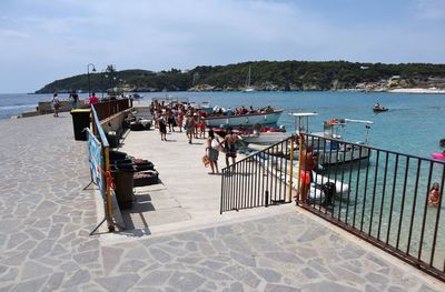 People at beach against sky