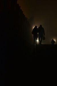 Silhouette man standing against sky at night