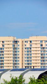 Buildings against blue sky on sunny day