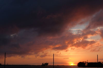 Scenic view of sea against cloudy sky at sunset