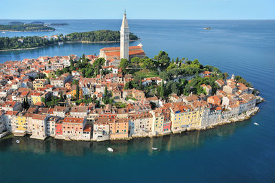 High angle view of buildings by sea against sky